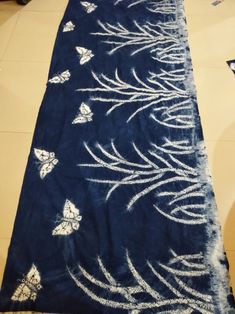 a blue rug with white butterflies on it in the middle of a flooring area