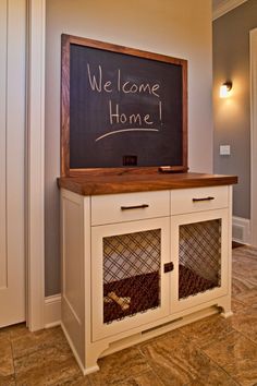 a chalkboard with the words welcome home written on it in front of a cabinet