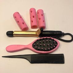 a hair brush, comb and other items on a table