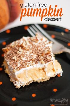 a piece of pumpkin dessert on a black plate with a fork and orange polka dots