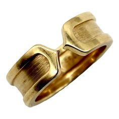 This is part of Chairish's Fine Jewelry Collection.  This 18k gold ring is a play on the classic double-c Cartier design. An abstracted c raises up as an exterior border that continues around the band. Two c’s back up against each other, meeting at a sharp point in the middle of the ring for a clean, modern look.  The outside border has a high polish, while the interior layer has a brushed gold finish. The design is subtle and simplistic, and the ring makes for an excellent staple in any jewelry Cartier Gold Ring, Rings Cartier, C Ring, Cartier Gold, 3 Stone Ring, 3 Stone Rings, 18k Gold Ring, Fine Jewelry Collection, Cartier Ring