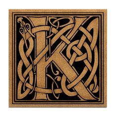 the letter k is made out of wood and has an intricate design on it's side