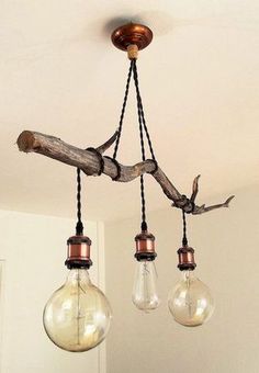 three light bulbs hanging from a wooden beam in a room with white walls and ceiling