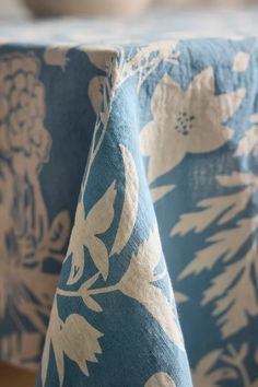 a blue and white table cloth with flowers on it