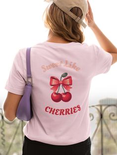 Indulge in the sweetness of summertime with the 'Sweet Like Cherries' T-shirt, featuring adorable cherries and a delicate pink bow. Crafted with soft, breathable fabric, this charming tee offers both comfort and style. Let the vibrant cherries and playful bow adorn you with a touch of whimsy and flair. Whether you're strolling through a sunny orchard or simply enjoying a leisurely day out, this shirt is sure to make a sweet statement. Embrace the joy of summer and spread positivity wherever you Scenario Game, Cherry Charm, Spread Positivity, Sweet Cherries, Pink Bow, Breathable Fabric, Cherry, Adult Outfits, Bathing Beauties