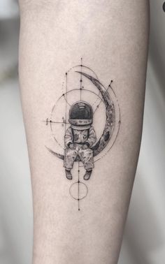 an astronaut sitting on the moon tattoo