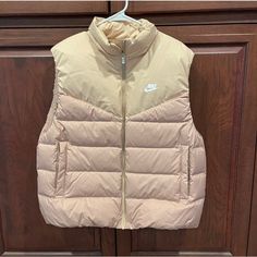 Nike Puffer Vest Women’s Large Neutral Color New With Tags Sporty, Athletic Nike Puffer Jacket For Spring Outdoor, Nike Casual Spring Puffer Jacket, Nike Fall Puffer Outerwear, Nike Puffer Outerwear For Fall, Tan Puffer Vest, Nike Puffer Vest, Puffer Vest Women, Nike Puffer, Nike Vest