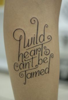 a tattoo that reads build hearts, can't be tamed on the leg