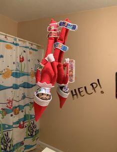 the elf is hanging upside down in the bathroom