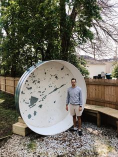 a man standing in front of a large white object