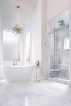 a bathroom with marble flooring and white bathtub next to a walk in shower