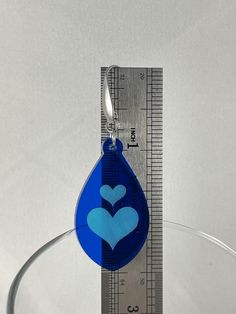 These acrylic heart inlay earrings feature stainless steel ear wires with teardrop accent. Lightweight and comfortable with silicone earring backs. These two tone blue heart inlay earrings are a perfect gift for Mothers' Day, Birthdays or any special occasion. Please keep in mind that each piece will vary slightly due to the variations of the acrylic material and the handmade nature of the product. The drop length is approximately 2.5” from top of ear wire to bottom of earring. Valentine's Day Teardrop Earrings, Blue Heart Earrings For Gift, Blue Heart-shaped Earrings For Valentine's Day, Blue Heart Charm Earrings For Valentine's Day, Valentine's Day Gift Blue Earrings, Blue Heart-shaped Earrings With Ear Wire, Blue Heart Earrings For Valentine's Day, Blue Earrings For Valentine's Day Gift, Personalized Blue Earrings For Gift