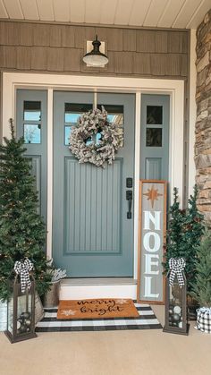 the front door is decorated with wreaths and christmas trees