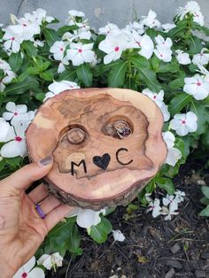 a person holding up a piece of wood that has been carved to look like a bear