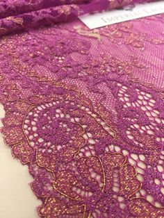 purple lace with gold details on it