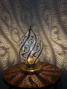 a decorative lamp sitting on top of a wooden table