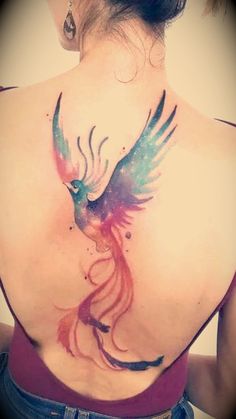 the back of a woman's shoulder with a bird painted on it