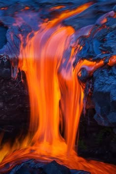 the water is flowing over rocks and lava