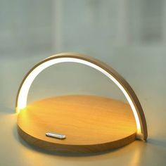 a light that is sitting on top of a wooden stand with a pen in it