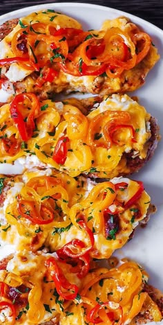 three pieces of bread with cheese and tomatoes on them, sitting on a white plate