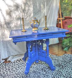 a blue table sitting on top of a leopard print rug