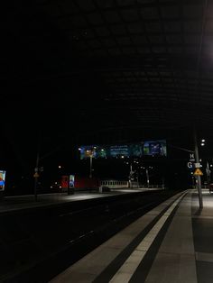 an empty train station at night with the lights on and no people or vehicles waiting