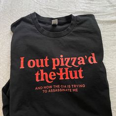 a black t - shirt that says, i out pizzad the hut and now the cia is trying to assinate me