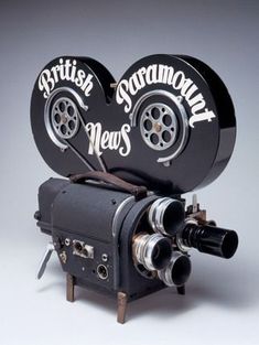 an old fashioned movie camera with the words british news on it's front and side