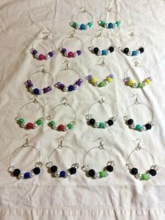 the wine glass charms have been made to look like they are filled with colorful beads