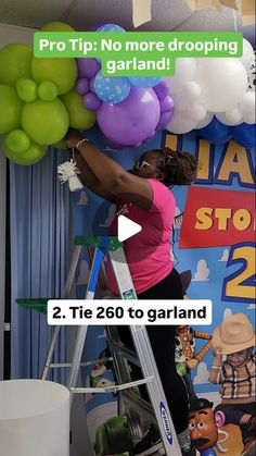 a woman on a ladder with balloons in front of her and the words pro tip no more dropping garland