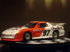 an orange and white car on a checkered table