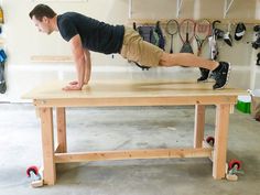 a man is doing push ups on a workbench