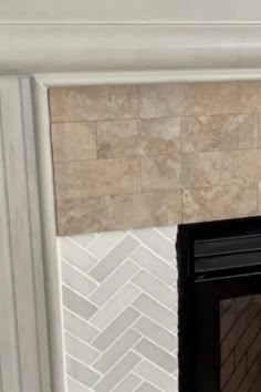 a fire place with a tile fireplace surround