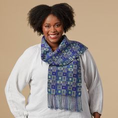 a woman wearing a blue scarf and white shirt with her hands on her hips, smiling at the camera