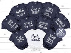 a bunch of shirts that are on top of a wooden table with the names of each bride and groom