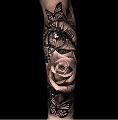 a black and white rose with butterflies on it's arm, in the shape of an eye