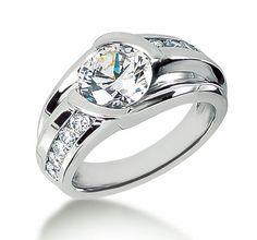 a white gold ring with diamonds on the sides and a center stone in the middle