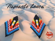 a pair of beaded earrings with the words namaste lenca on it