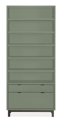 a green bookcase with three drawers