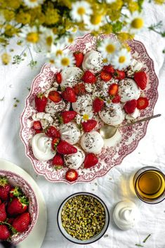 strawberries and other desserts on a table with flowers