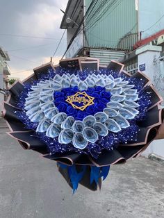 there is a blue and white flower on the street