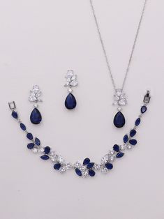 "This earrings, necklace and bracelet set are elegantly designed with AAA grade sapphire blue cubic zirconia stones in shapes of pear, marquise and teardrops. Measuring 1 1/4\", these brilliant earrings are perfect for a wedding or any special occasion. Bracelet measures 7\". Matching necklace completes the look and is adjustable from 16-18\" long. Extenders for bracelet and necklace can be requested. All jewelry features high quality electroplating that does not fade or chip and is nickel free Royal Blue Necklace Jewelry, Sapphire Set Jewelry, Dark Blue Jewelry Set, Jewelry For Navy Blue Formal Dress, Matching Jewelry Set, Sapphire Wedding Jewelry, Silver And Blue Necklace, Blue Dress Jewelry Ideas, Royal Jewelry Aesthetic