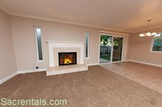 empty living room with fireplace and sliding glass doors