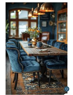 a dining room with blue chairs and a wooden table