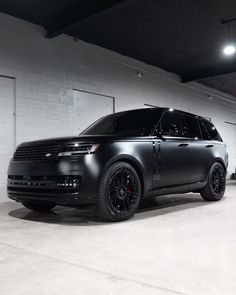 a black range rover parked in a garage