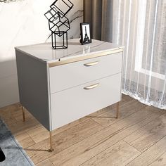 a white chest of drawers sitting on top of a wooden floor