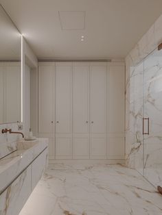 a large bathroom with marble walls and flooring