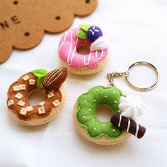 three miniature donuts with different toppings on them