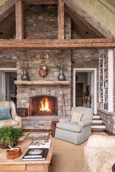 a living room filled with furniture and a fire place in front of a stone fireplace