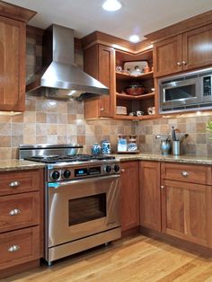 a kitchen with wooden cabinets and stainless steel stove top oven in the center, surrounded by wood flooring